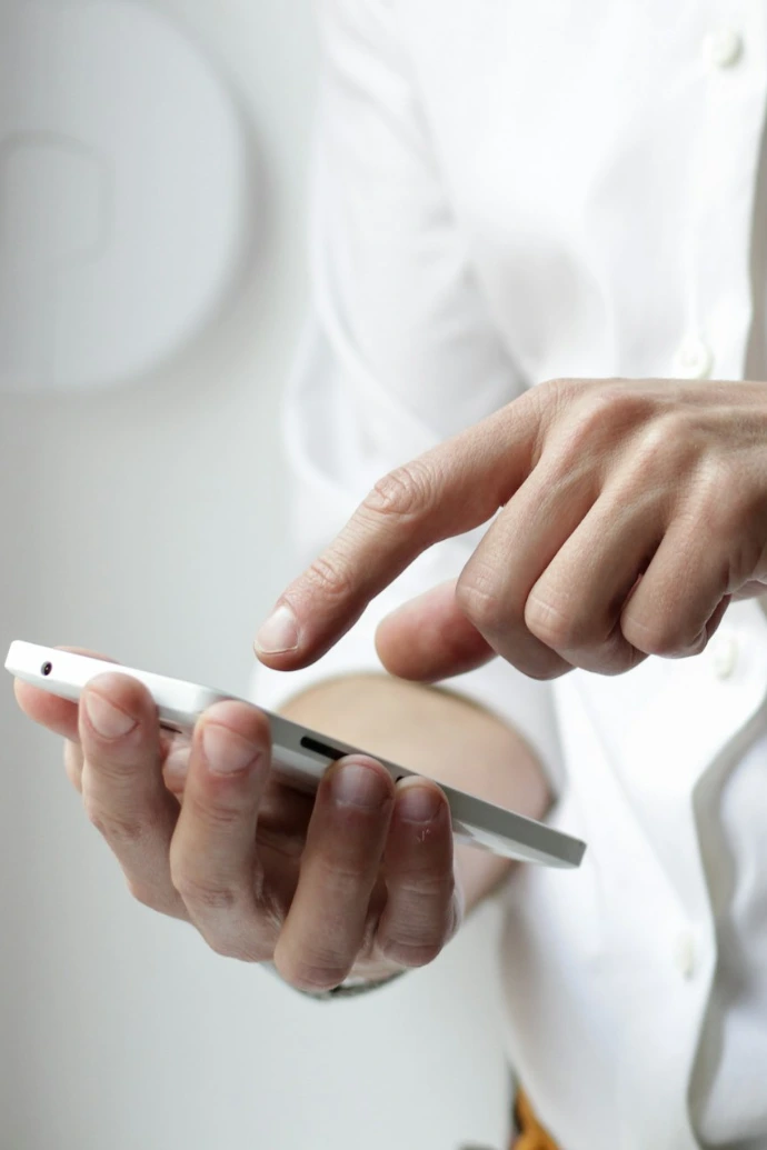 person holding white Android smartphone in white shirt